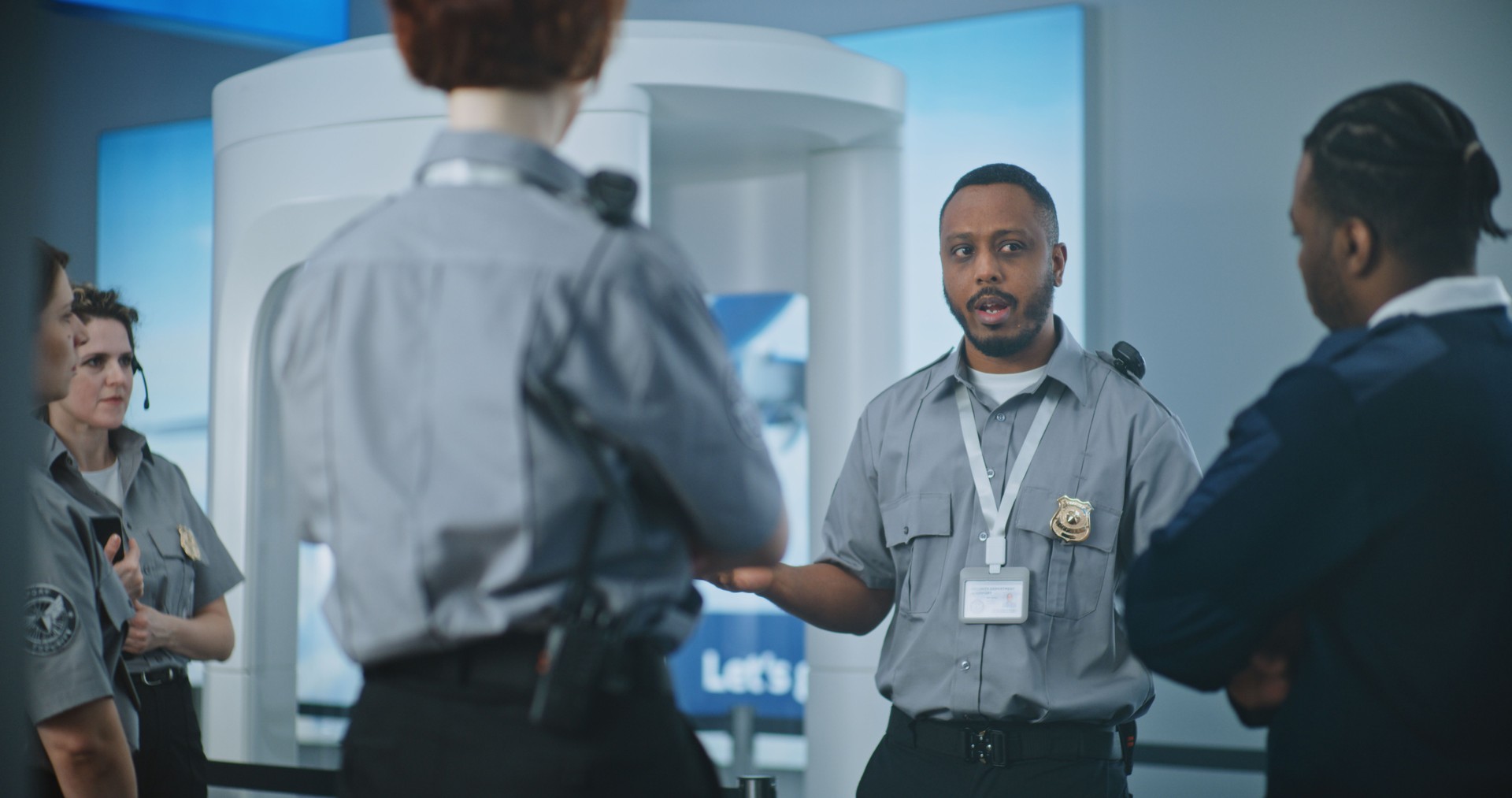 TSA Officer Holding Briefing, Providing Instruction to Team of Workers About Screening Procedures