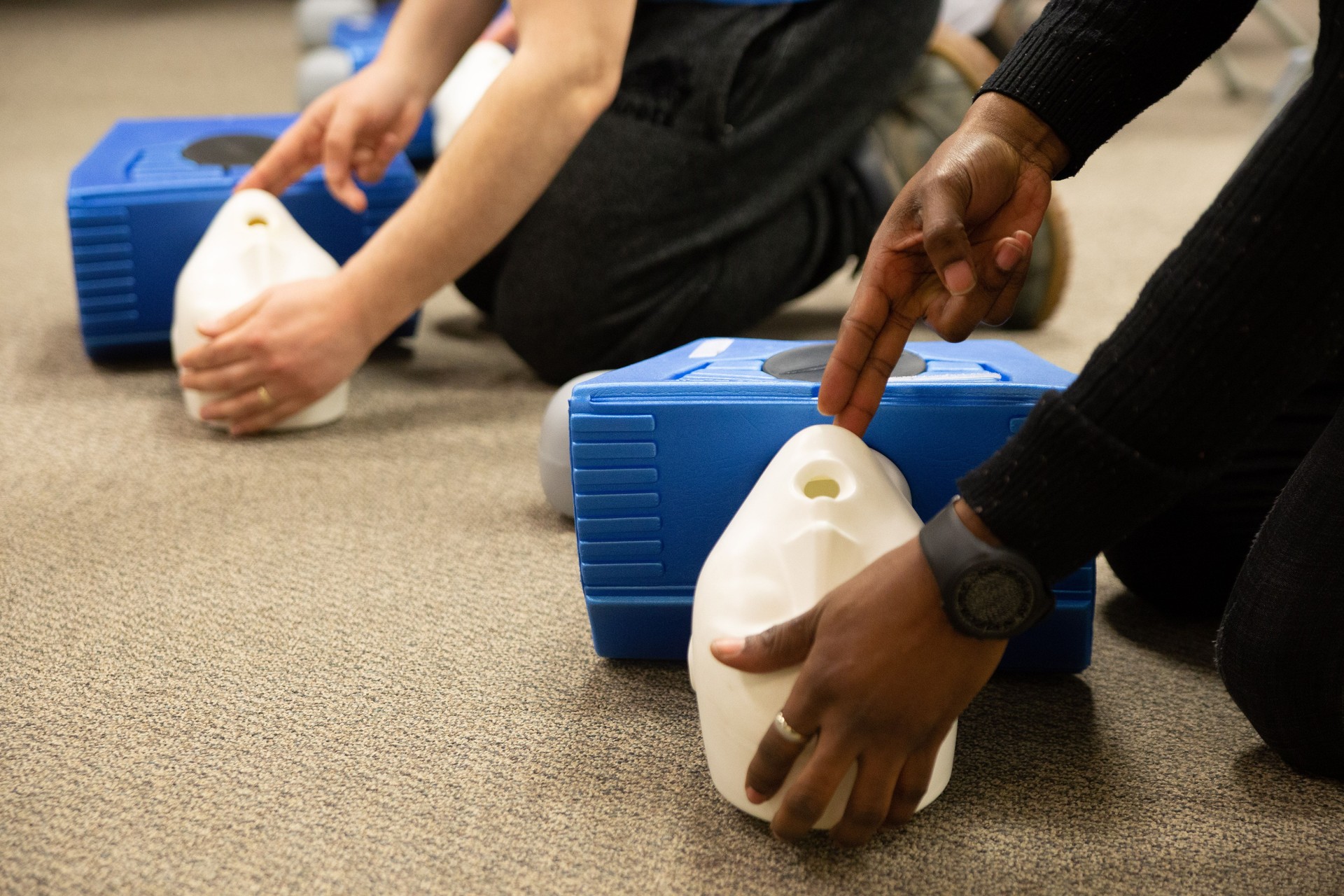 CPR training class by security guard in office