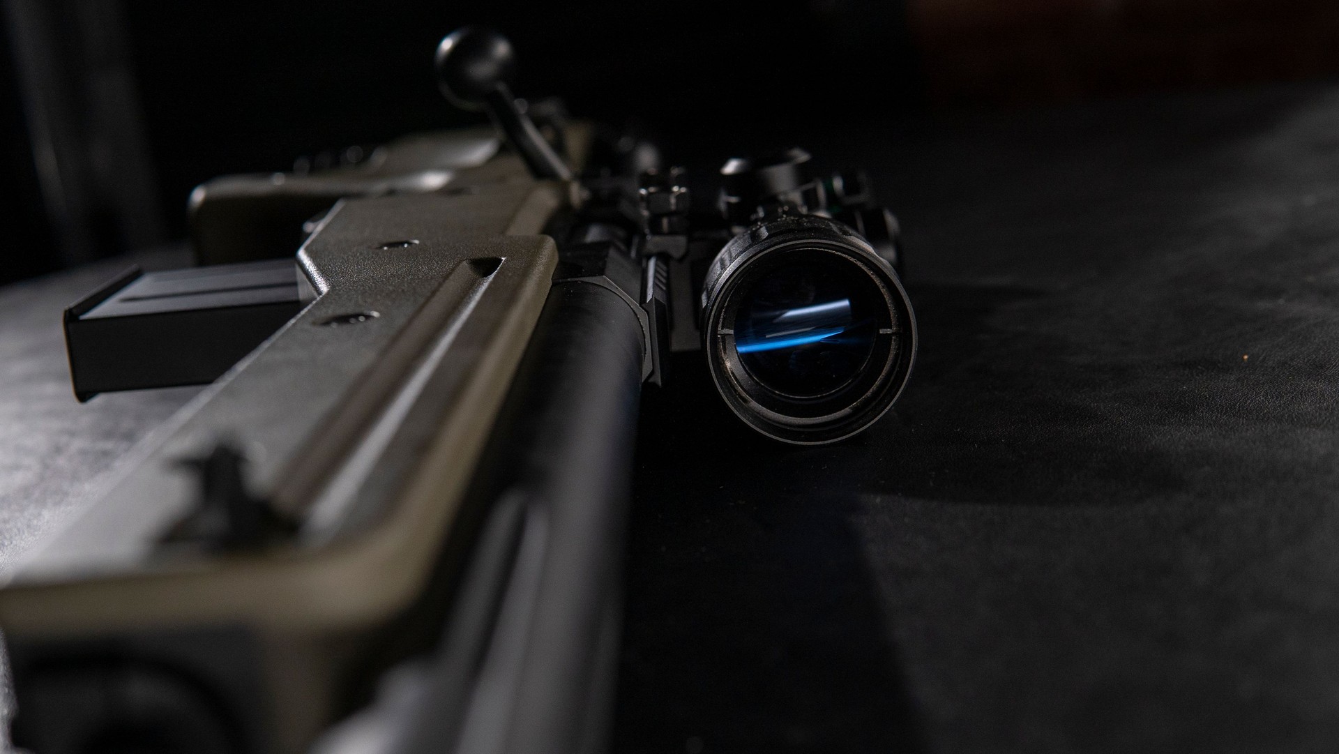 Resting on the table is a sniper rifle